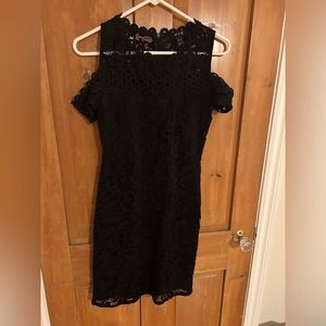 Elegant lace dress with cold shoulder sleeves.